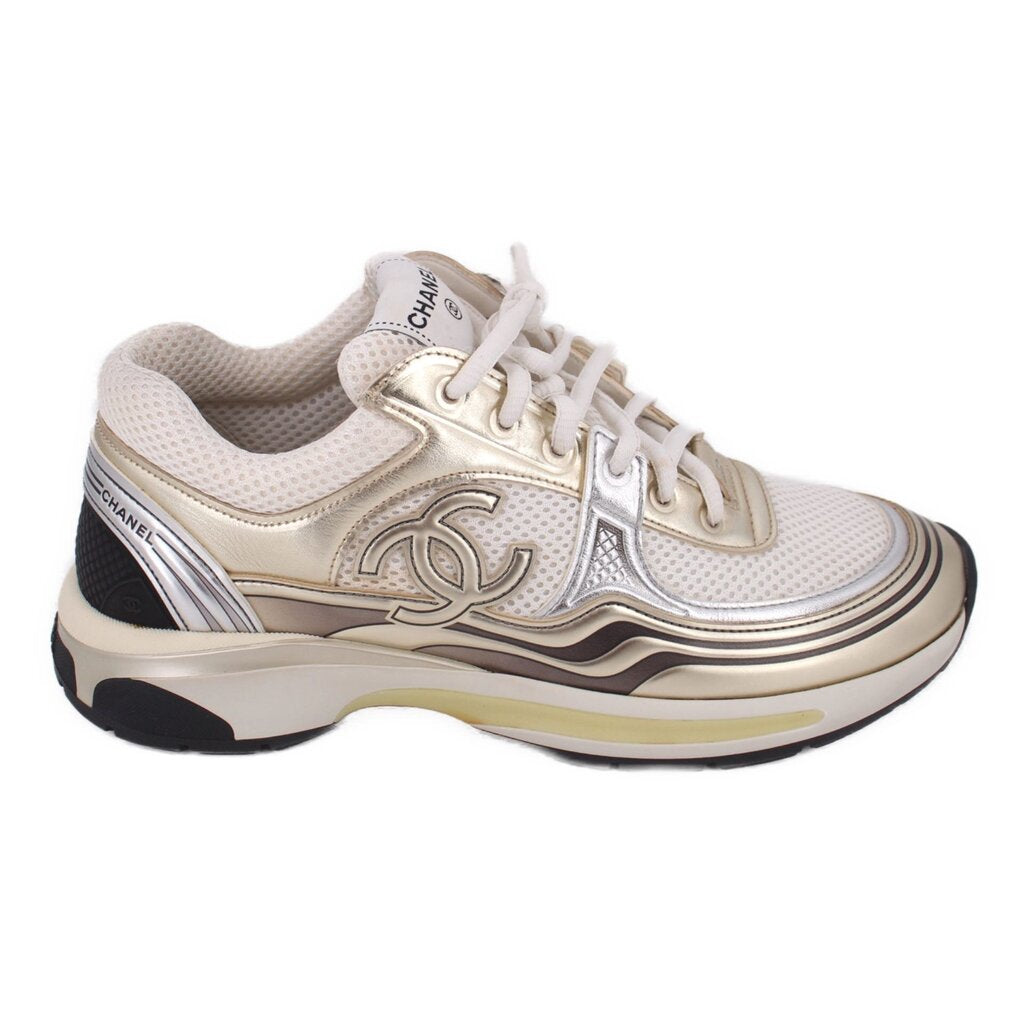 CHANEL tennis sneaker, white mesh upper with gold accents and chunky metallic sole