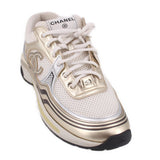 CHANEL tennis sneaker in white and gold, lace-up with signature emblem on side
