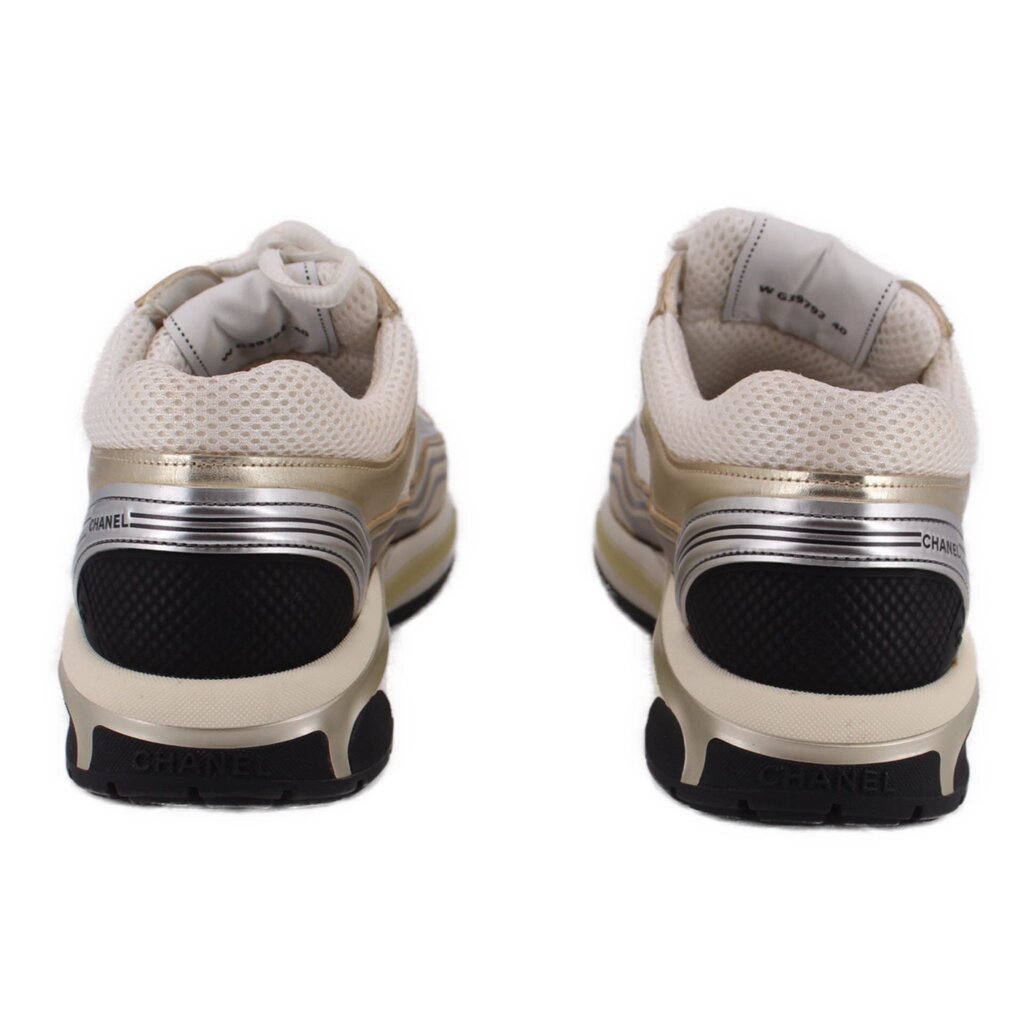 CHANEL tennis sneakers with white back panels, gold trim, and black outsole