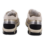 CHANEL tennis sneakers with white back panels, gold trim, and black outsole