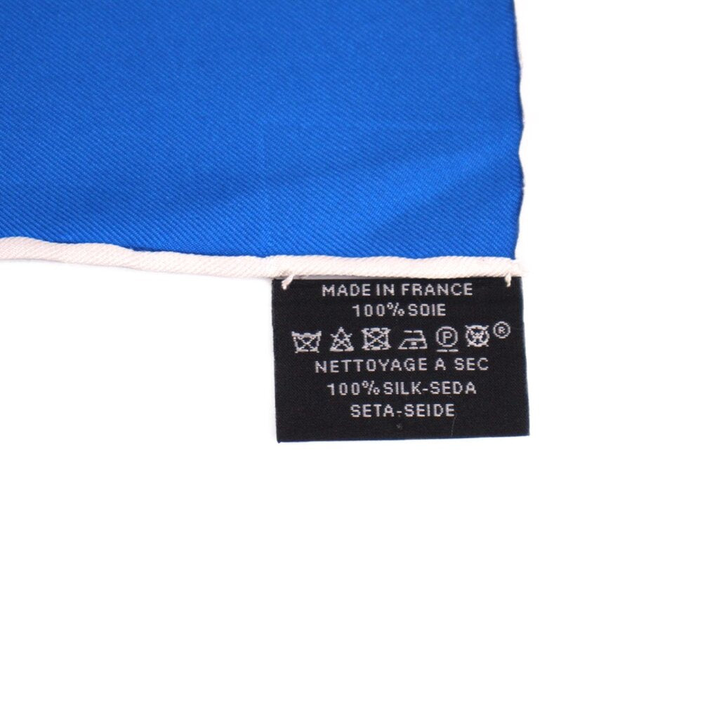 Blue silk scarf care label reading Made in France and 100% silk