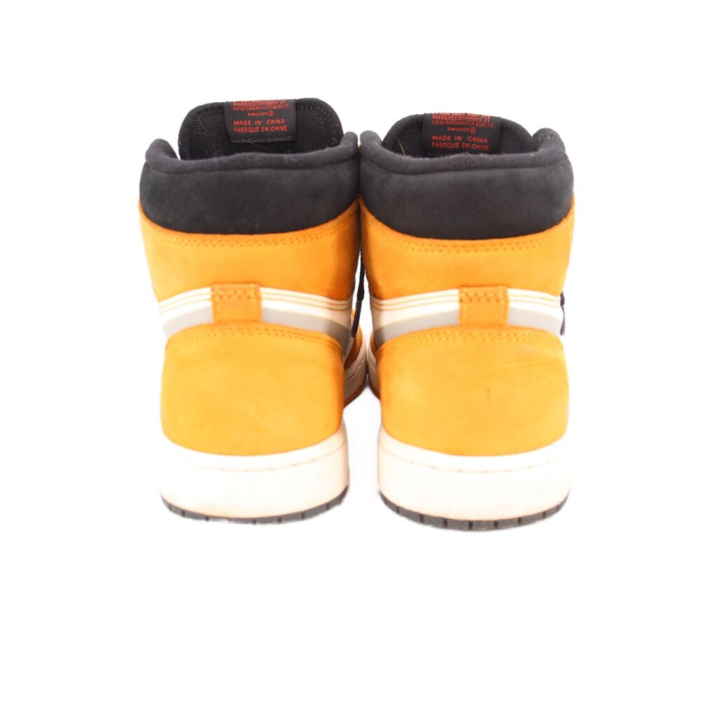 Back view of high-top sneakers in light yellow with black heel collars and white midsole