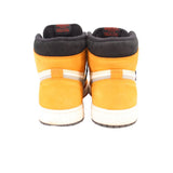 Back view of high-top sneakers in light yellow with black heel collars and white midsole