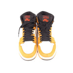 Pair of high-top sneakers with black tongue accents, light yellow leather panels, orange laces