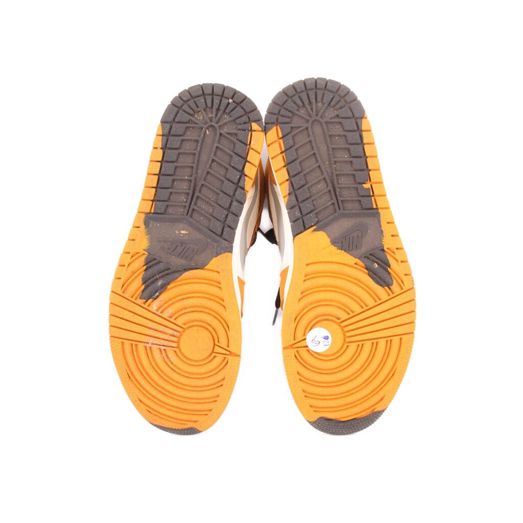 Outsoles of high-top sneakers with gray tread and orange rubber, white midfoot panels