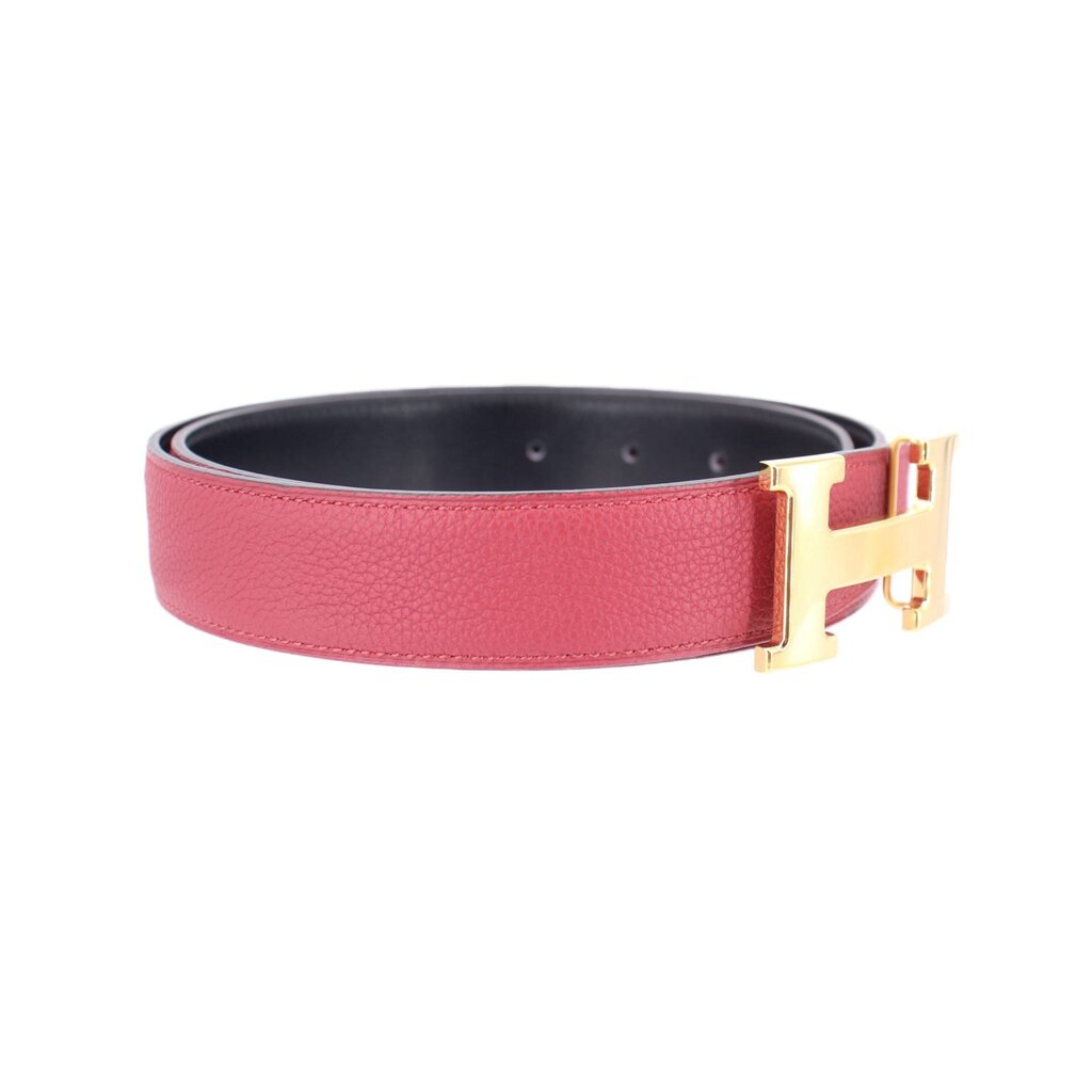 Red leather belt with black underside and gold-tone buckle hardware