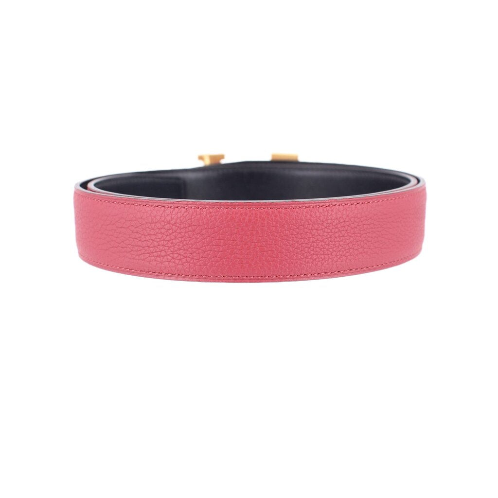 Red leather belt with black interior lining and gold-tone buckle tabs