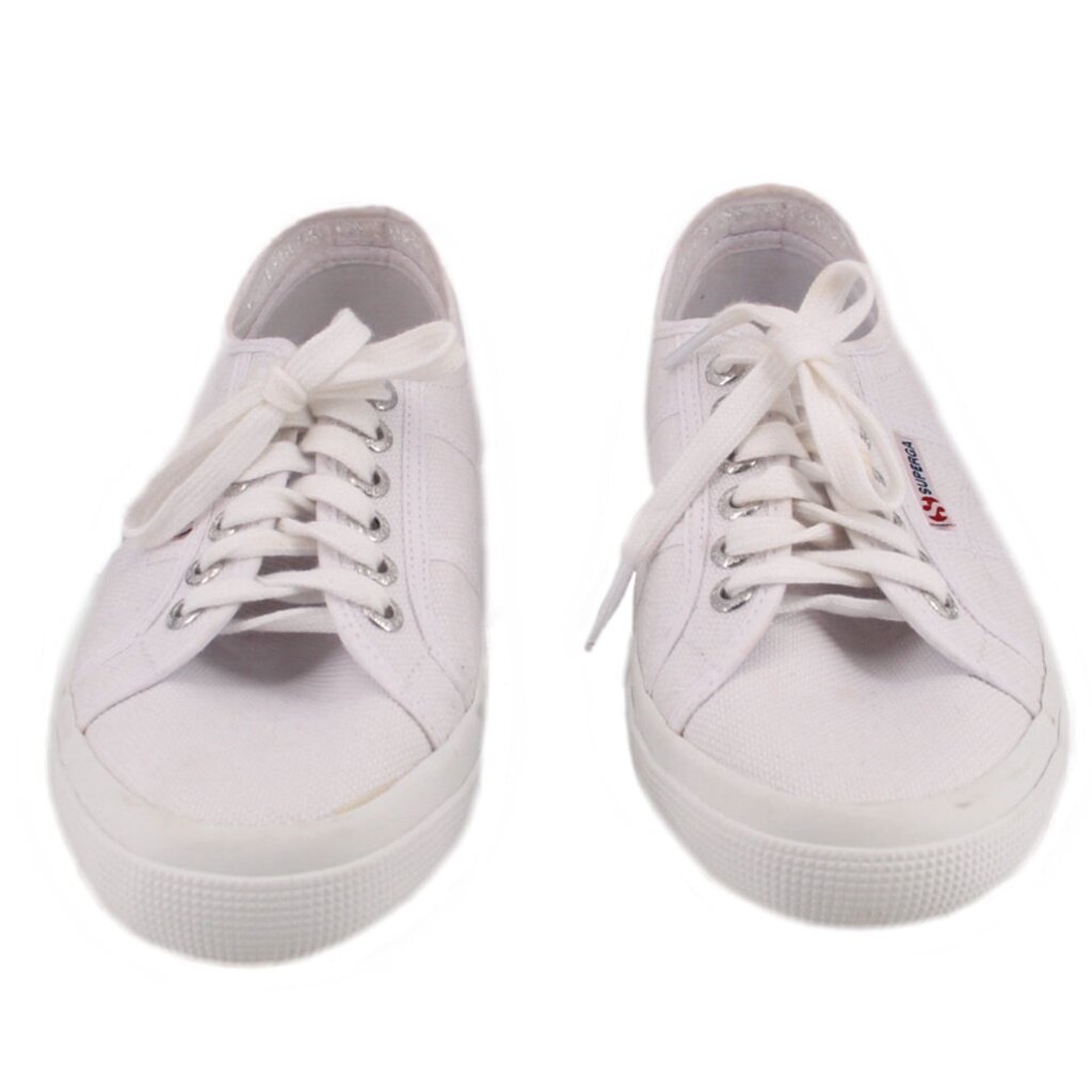 White canvas low-top sneakers with lace-up uppers and metal eyelets