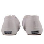 White canvas sneakers with SUPERGA heel label and rubber toe bumper.