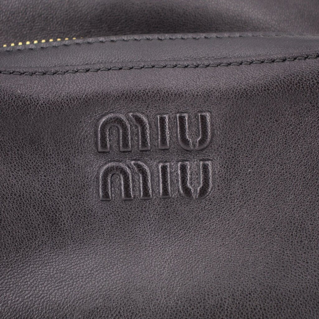 MIU MIU embossed logo on black leather pocket of shoulder bag