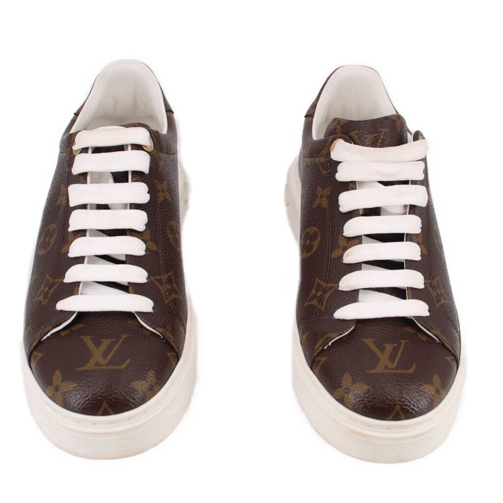 Pair of brown monogram low-top sneakers with white laces and white soles.