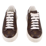 Pair of brown monogram low-top sneakers with white laces and white soles.