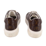 Brown monogram sneakers with white laces, rear view and embossed heel logo.