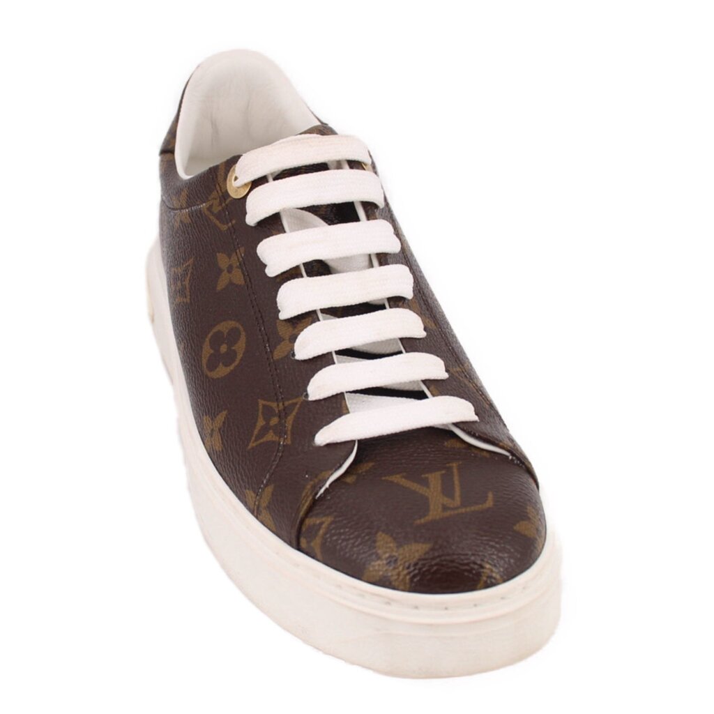 Brown monogram low-top sneakers with white laces and white rubber sole.