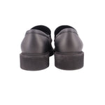 Back view of black leather loafers with low stacked heel