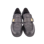 Pair of black leather loafers with gold LV-style hardware and cross-stitch detail