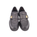 Pair of black leather loafers with gold LV-style hardware and cross-stitch detail