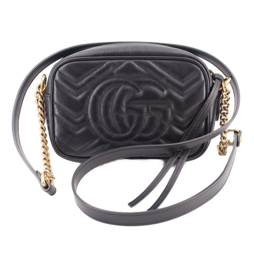 Black quilted leather crossbody bag with large embossed GUCCI double-G and crossbody strap