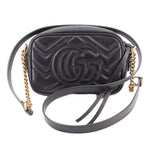 Black quilted leather crossbody bag with large embossed GUCCI double-G and crossbody strap
