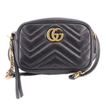 Black quilted leather crossbody bag with gold GUCCI double-G logo and chevron stitching