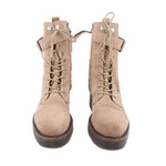 Pair of tan suede combat boots with lace-up fronts and ankle collar straps