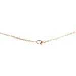Gold-tone necklace with small dark lock-shaped link at center on fine chain