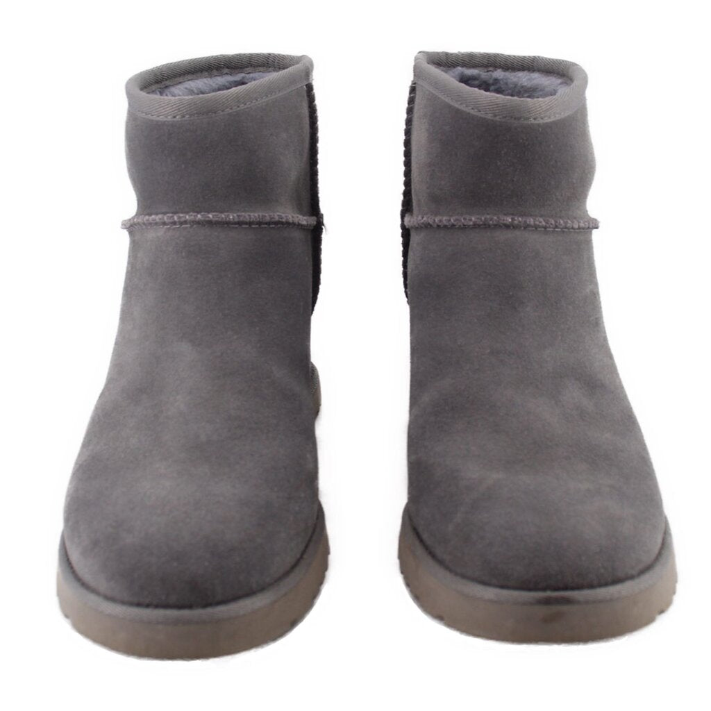 Gray suede ankle booties showing heel backs and stitched collars