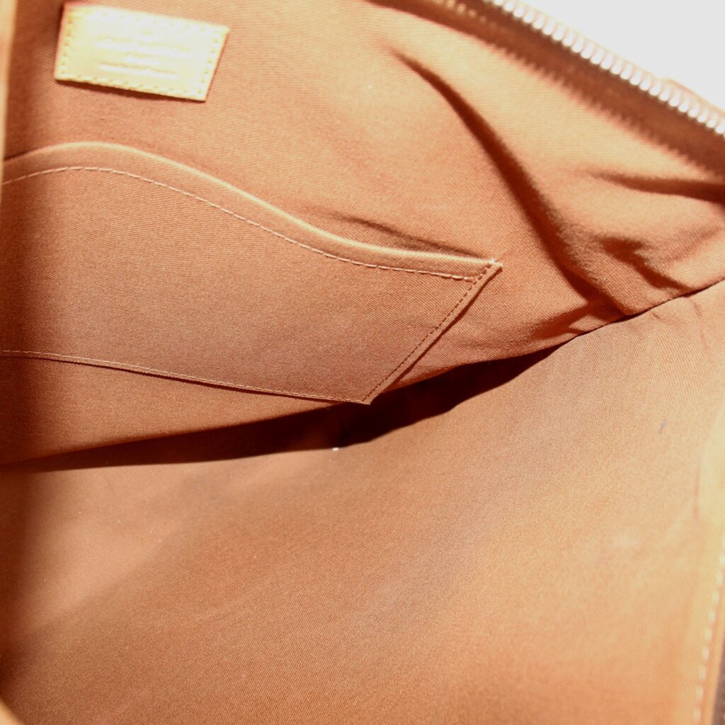 Tote bag interior with tan fabric lining and stitched pocket opening
