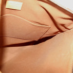 Tote bag interior with tan fabric lining and stitched pocket opening