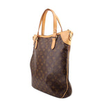 Monogram tote crossbody bag side view with tan strap hardware and dark brown patterned leather