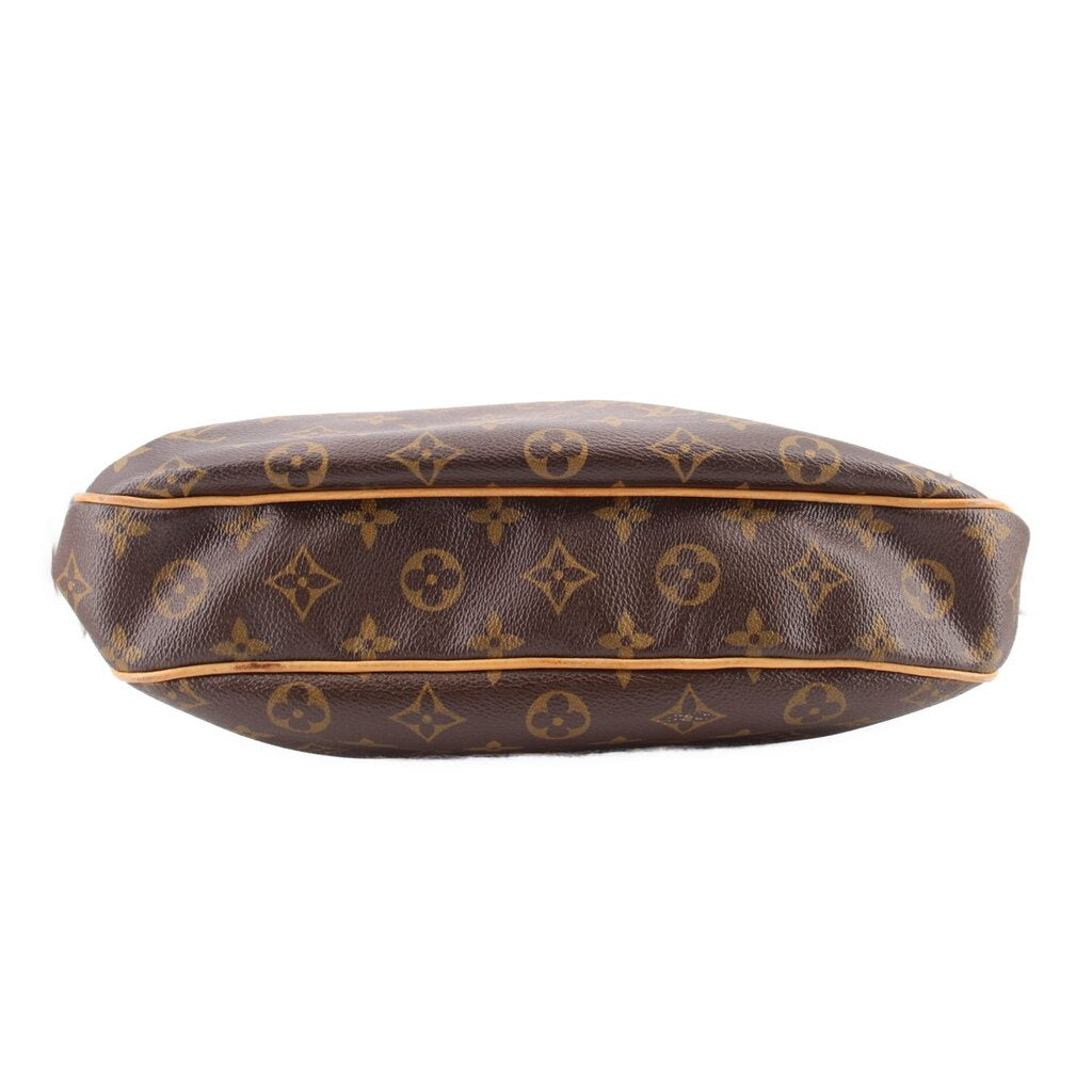 Monogram tote crossbody bag underside view with rounded base and dark brown patterned leather