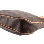 Close-up of monogram tote bag rounded side and seam with tan edge trim on dark brown leather