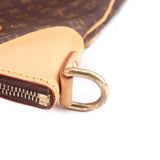 Monogram crossbody bag end with silver-tone D-ring and tan leather zipper pull