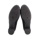 Bottom view of black Mary Jane heels with textured rubber sole
