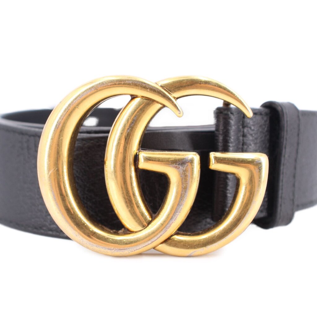 Black leather belt with gold-tone GG double ring buckle, close-up