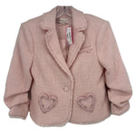 Pink tweed blazer with ruffled lapel and heart-shaped embellishments