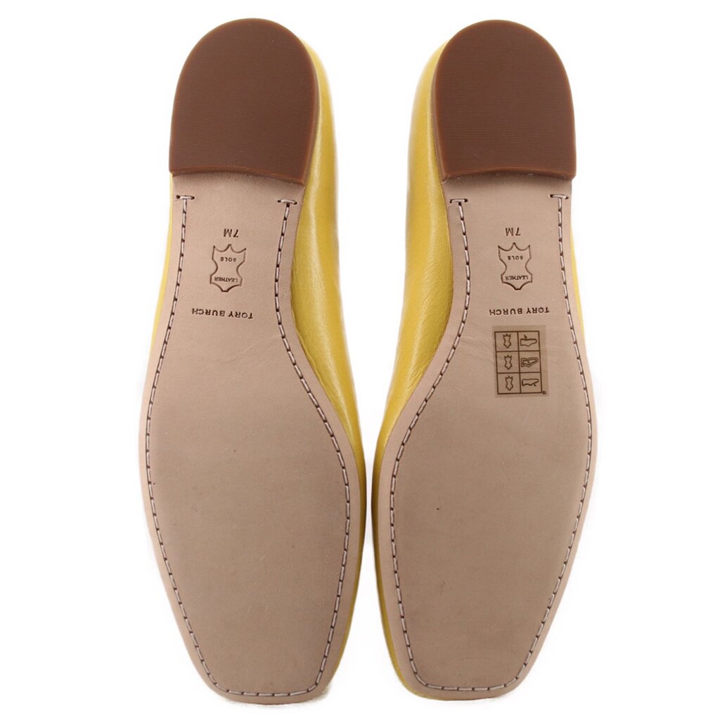 Yellow flats underside view with light insole and stitched leather panels