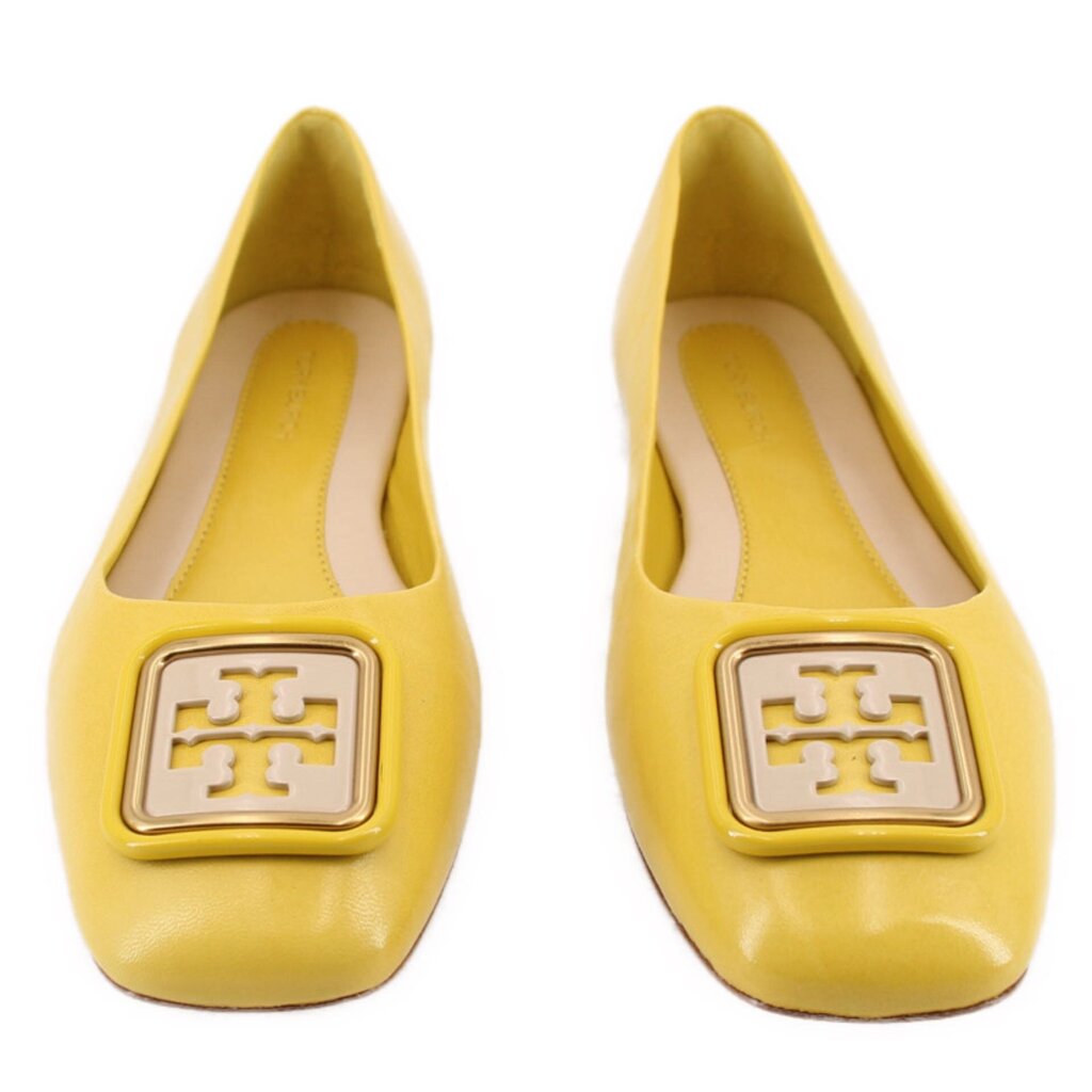 Yellow leather flats showing round toe and gold-tone logo buckle on top