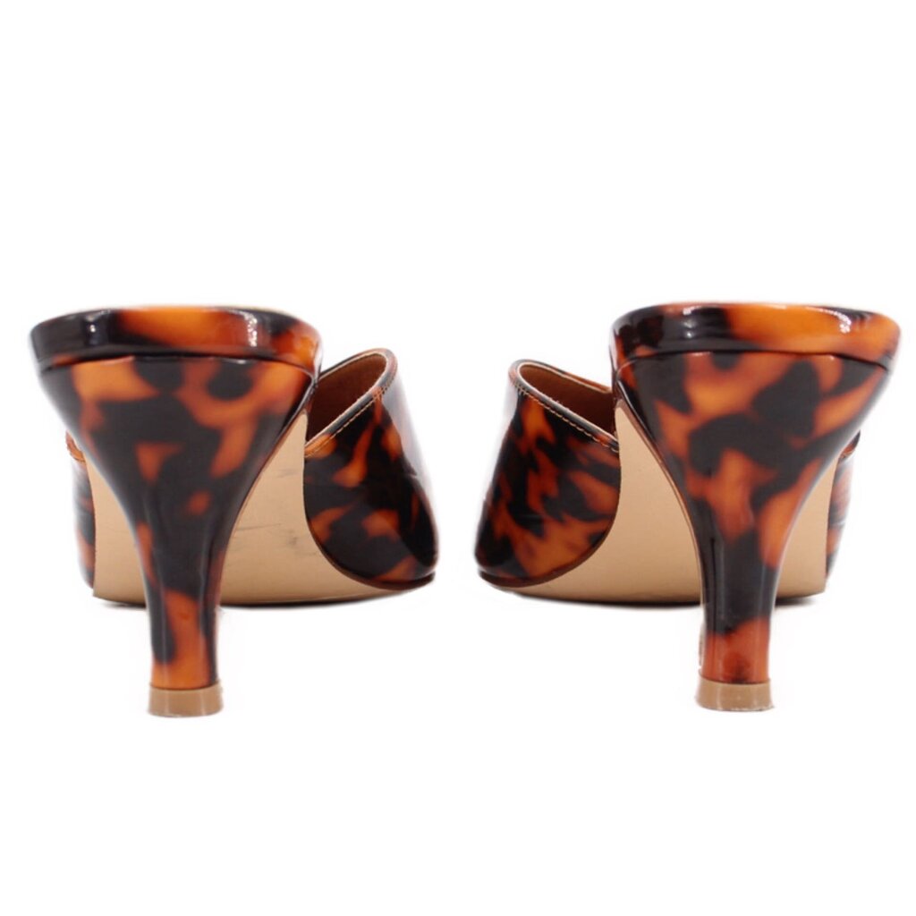 Back view of brown tortoise patent mule heels with open sides and slim heel