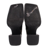 Black patchwork bootie heels and treaded outsoles