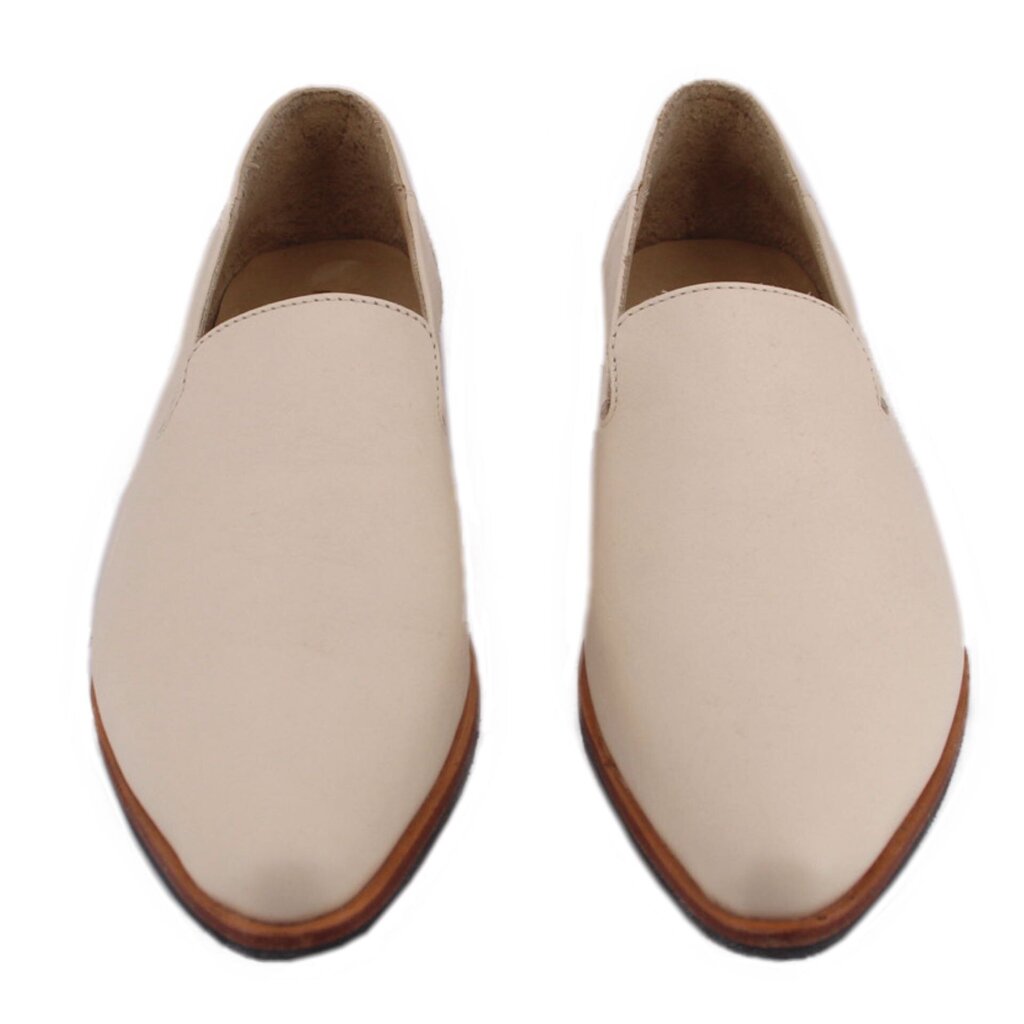 Pair of cream pointed slip-on flats with brown soles