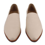 Pair of cream pointed slip-on flats with brown soles