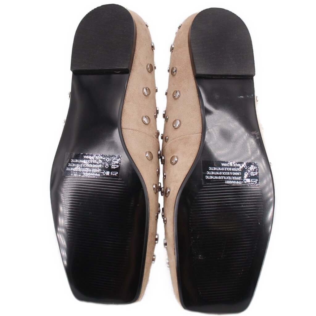 Tan stud flats outsole view with black sole and cushioned insole