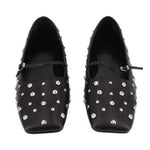 Pair of black pointed-toe flats with silver-tone studs and low-profile strap