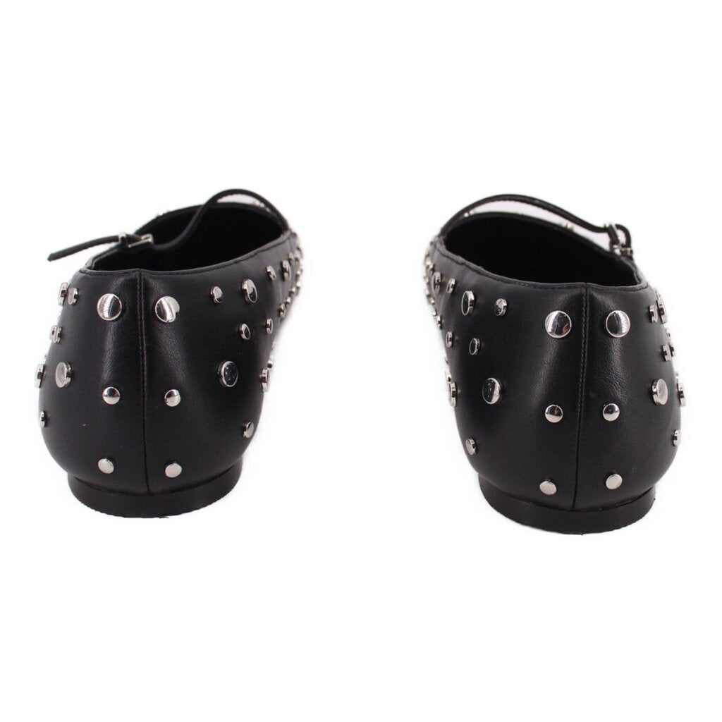 Black flats with side profile strap and silver-tone metal studs around upper