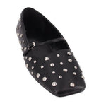 Black studded flats with pointed toe and silver-tone metal eyelet accents