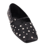 Black studded flats with pointed toe and silver-tone metal eyelet accents