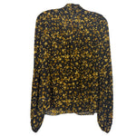 Back of the black floral blouse, showing long sleeves and a gathered upper-back seam