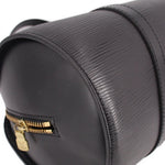Black mini pouch bag with gold-tone zipper pull and corner leather stitching
