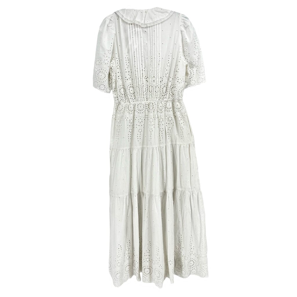 White eyelet dress with puff sleeves, high neck and gathered tiered skirt